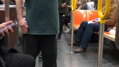 Drunk guy spins around fast inside a subway train