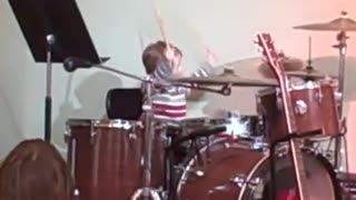 Kazou plays the drums at church