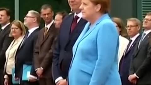 German Chancellor Angela Merkel stumbles and falls to the ground at a meeting in Berlin