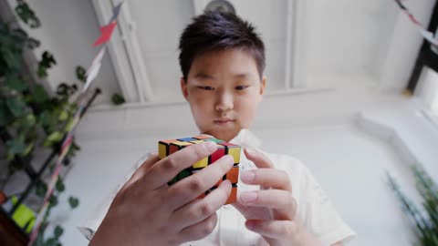 Boy Playing a Rubik's Cube