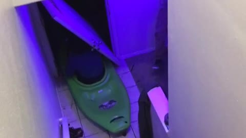 Guy in green kayak slides down stairs