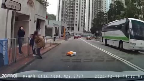 Mother irresponsibly drags young child, getting struck and sent flying