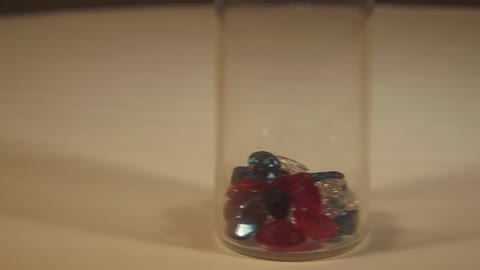 Gemstones, Red Rubies, White Zircons And London Blue Topaz In A Jar...
