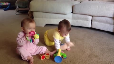Twin baby laughing talking to each other