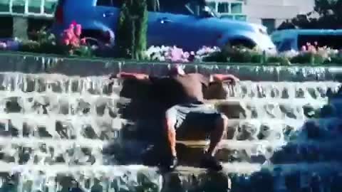 Man passed out on fountain
