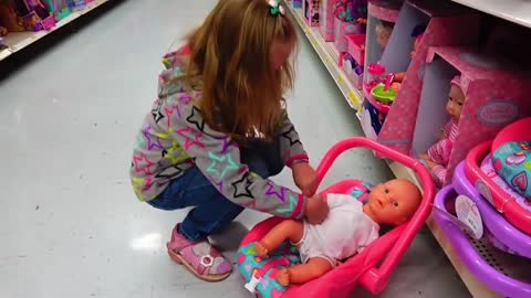Funny baby doing shopping at the supermarket