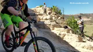 Guy green shorts mountain bike going down mountain rocks fail