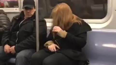Red hair woman falls asleep into pole on subway