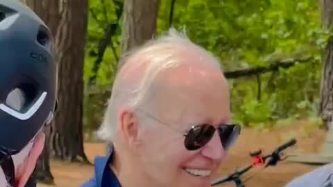 Biden whispers to young girl on biking trail…and starts sniffing.