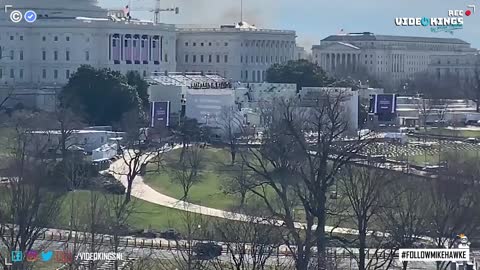 Smoke rise behind the U.S. Capitol building, emergency announcement playing.