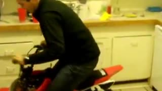 Red motorcycle does donuts in kitchen