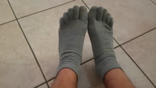 foot with grey five fingers socks