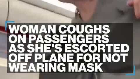 Woman coughs on passengers as she's escorted off plane