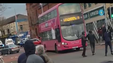 Watch Bus firebombed and police attacked during night of violence in Belfast