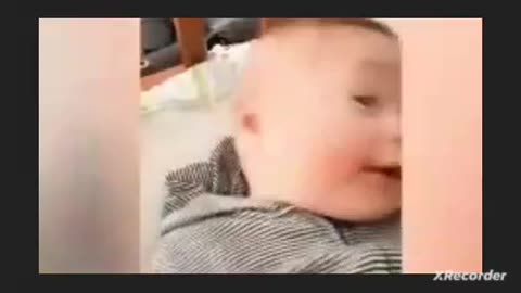 Cute babies reaction when small puppy licks his cheeks