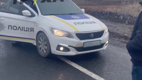 Police of Ukraine escort a group of luxury cars towards the border