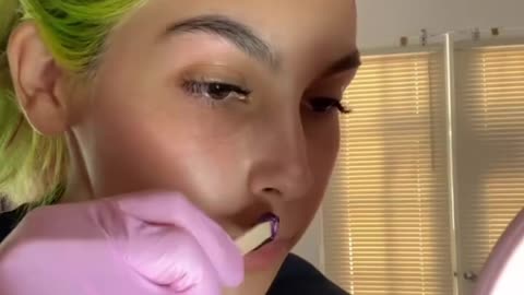 @nanis__aesthetics waxes upper lip with Sexy Smooth Purple Seduction Hard wax