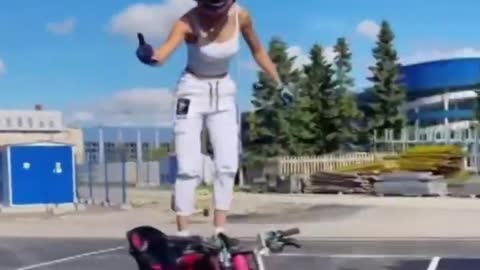 Russian stunt girl wows with mind-blowing tricks on motorbike