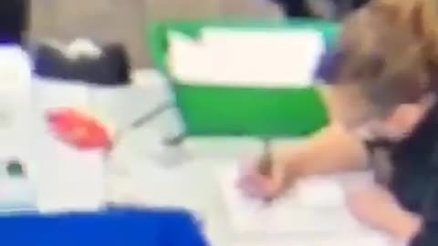 Election worker filling in ballots