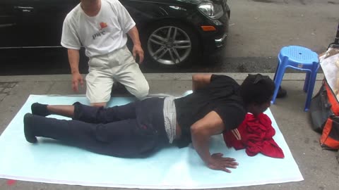 Luodong Massages Man With Afro Pick On Sidewalk