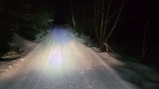 Snowmobile trail grooming in the national forest.