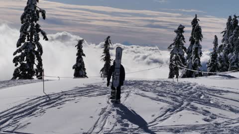 Skier at the peak of a snowy mountain