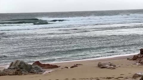 Dozens clear up spilled plastic pellets on Spanish beach
