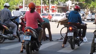 Vietnam, HCMC, Q7 - Bicycle riding cardboard recycler - 2014-05