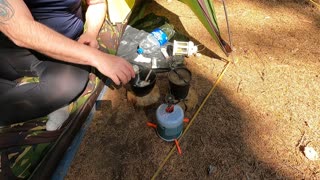 Making coffee in a tent while wildcamping