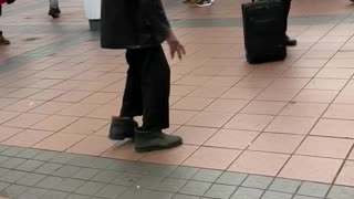 Old man dancing to music subway station