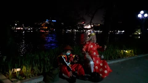 Old men play erhu by romantic lake