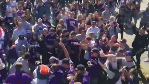 Shirtless man does back flip into crowd in purple