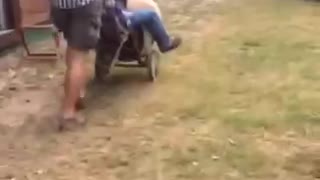 Guy pushes friend on concrete mixer