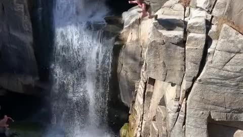 Girl jumps into beautiful hidden waterfall