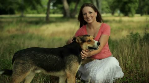 girl with her dogs smiles at camera