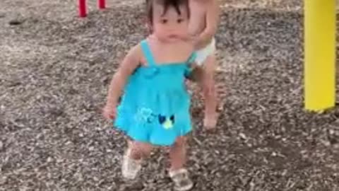 Sweet baby boy holds hands with little girl at the park👏🏽