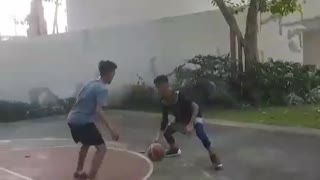 Kid in black throws basketball hits face