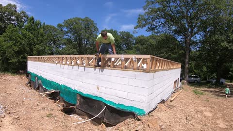 Installing Floor Trusses and building the basement walls