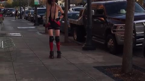 Man in red outfit skates and falls on street