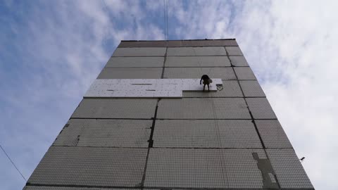 Climber working on a multi story building