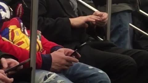 Man clips fingernails on subway train