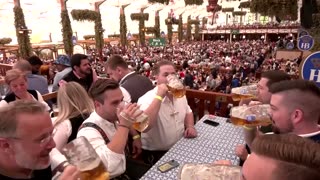 Oktoberfest beer-drinkers celebrate half time