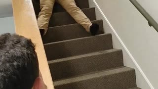 Guy in blue shirt falling down stairs