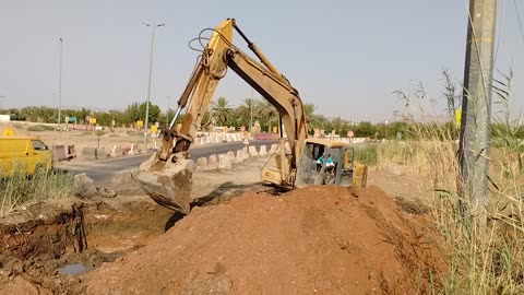 Komati excivator cutting rock and steep slop