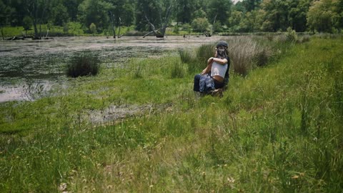 Loving couple sitting on the shore of a lake outdoors