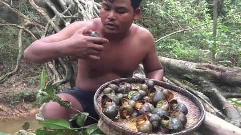 Primitive Man Gathering African Snails and Eating!