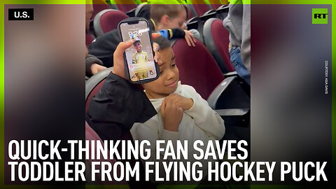 Quick-thinking fan saves toddler from flying hockey puck