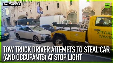 Tow truck driver attempts to steal car (and occupants) at stop light