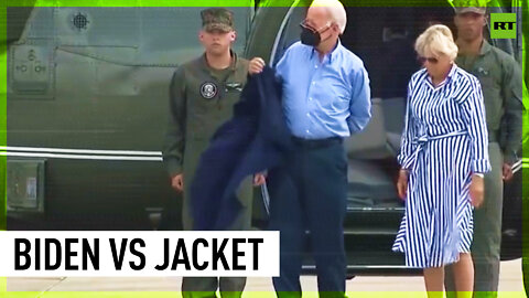 (Almost) gone with the wind: Biden struggles to put his jacket on