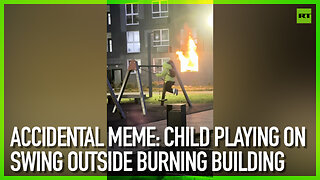 Accidental meme: Child playing on swing outside burning building